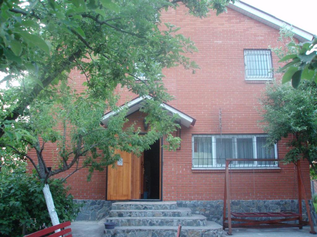 a red brick building with stairs leading to a door at Lux villa on the river Dnipro in Kirovskoye