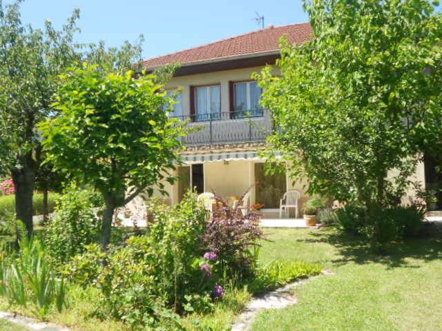 a house with a balcony on top of a yard at Chez Colombine in Chaponost