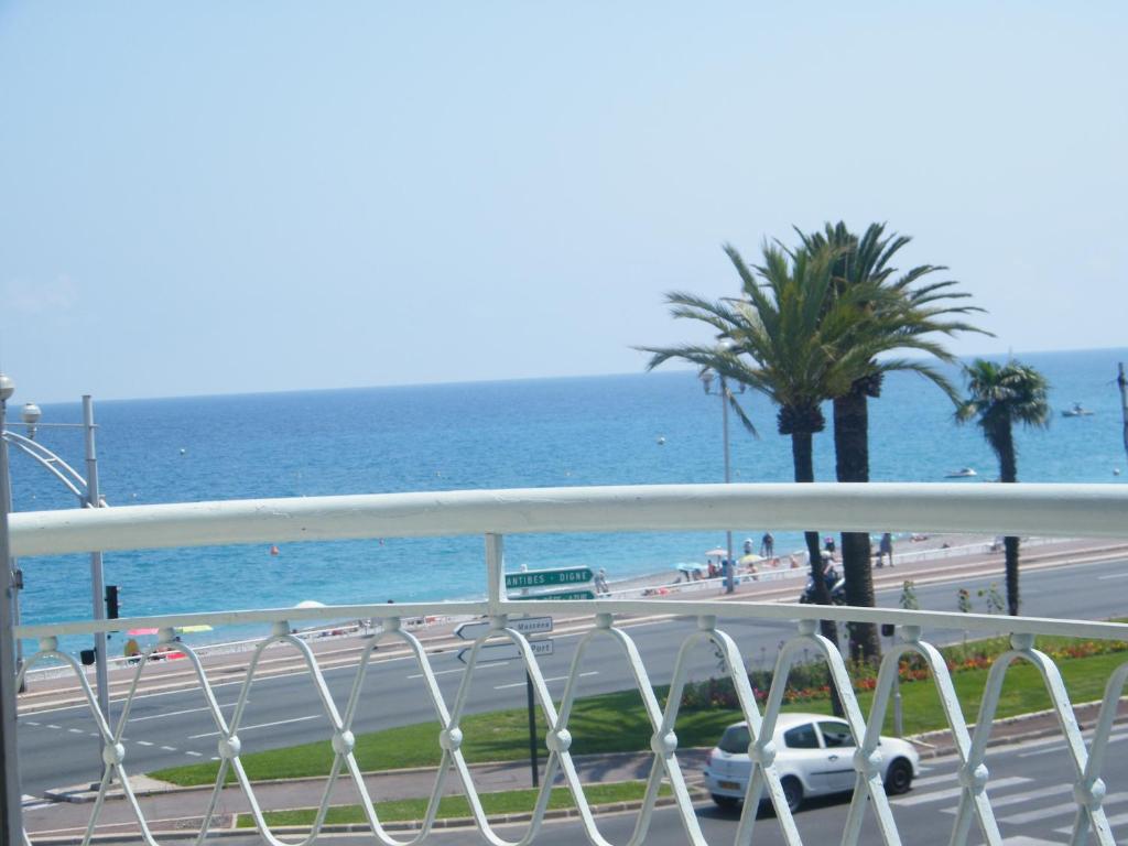 a balcony with a view of the ocean and a highway at Palais HenriIV in Nice