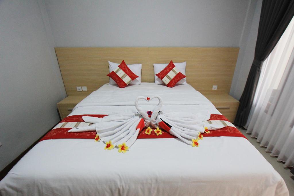Postel nebo postele na pokoji v ubytování Tom Guest House