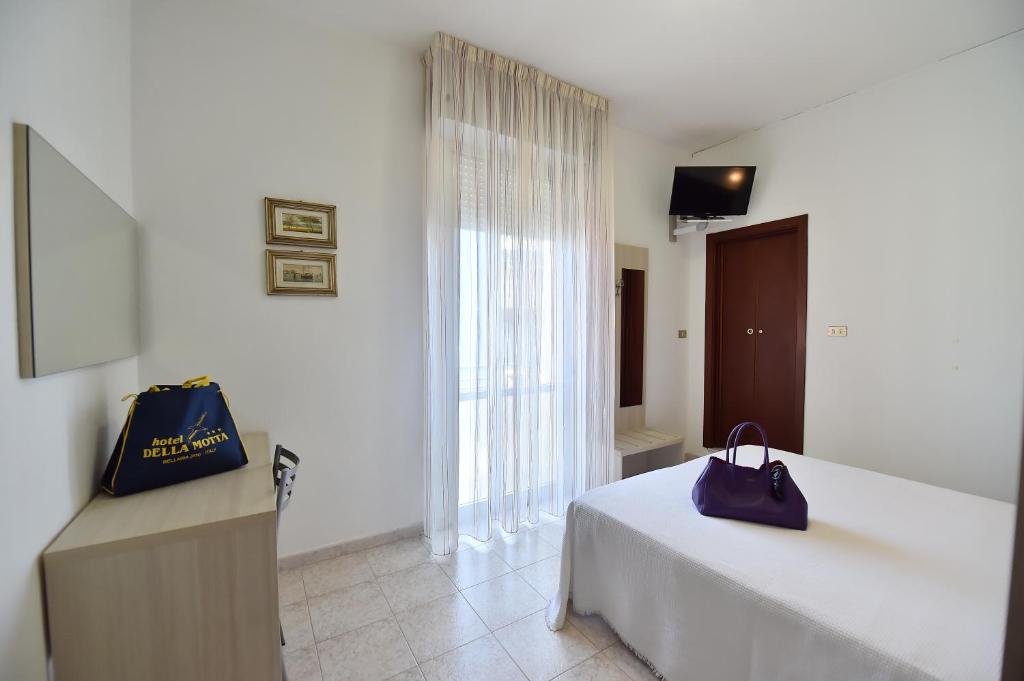 Postel nebo postele na pokoji v ubytování Hotel Della Motta
