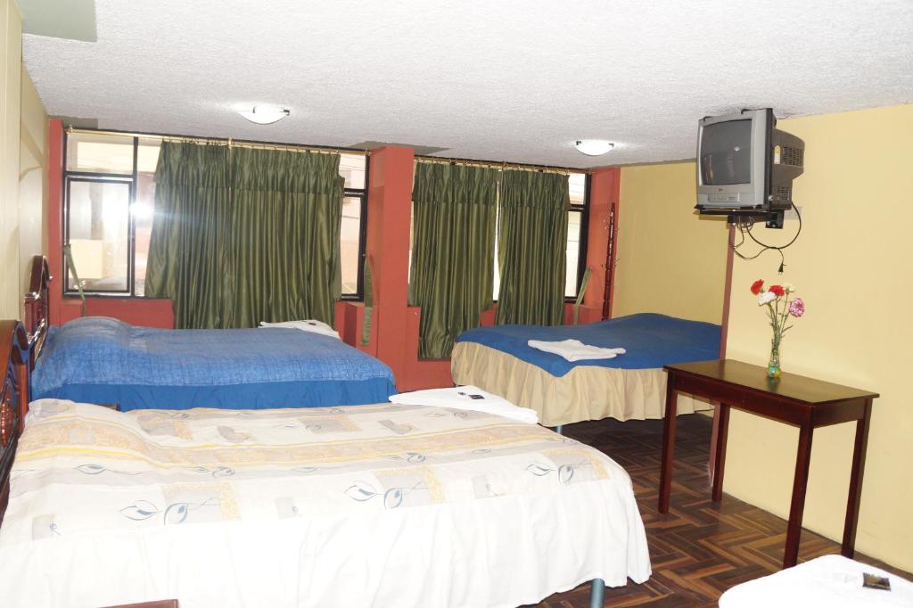 Postel nebo postele na pokoji v ubytování Hostal Pucará