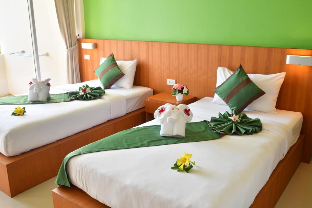 Postel nebo postele na pokoji v ubytování The Touch Green Naiyang Hotel & Fitness