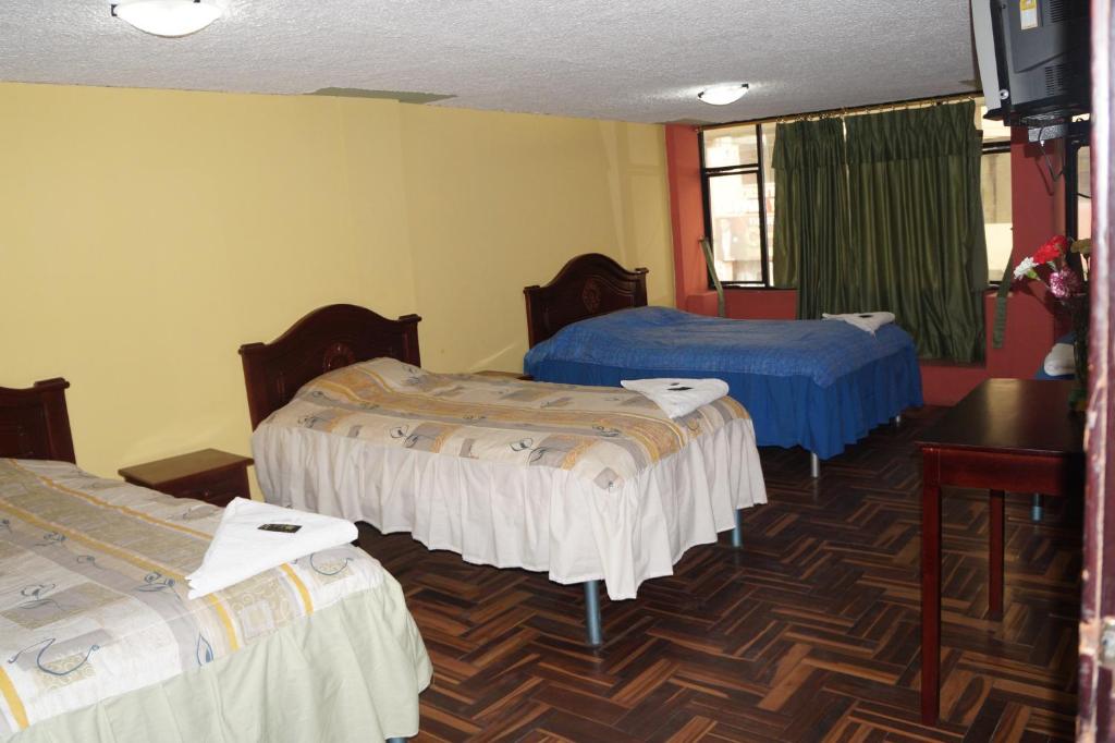Postel nebo postele na pokoji v ubytování Hostal Pucará