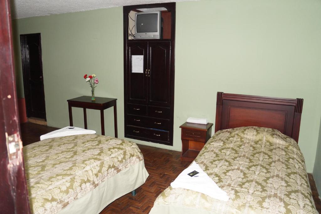Postel nebo postele na pokoji v ubytování Hostal Pucará