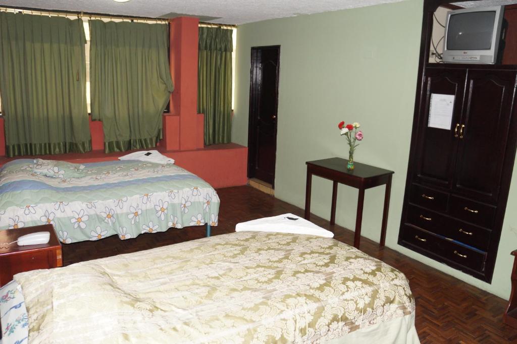 Postel nebo postele na pokoji v ubytování Hostal Pucará