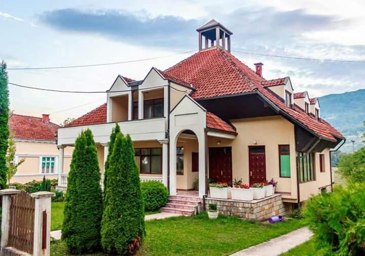 a large white house with a red roof at Apartment Aleksandra in Bajina Bašta