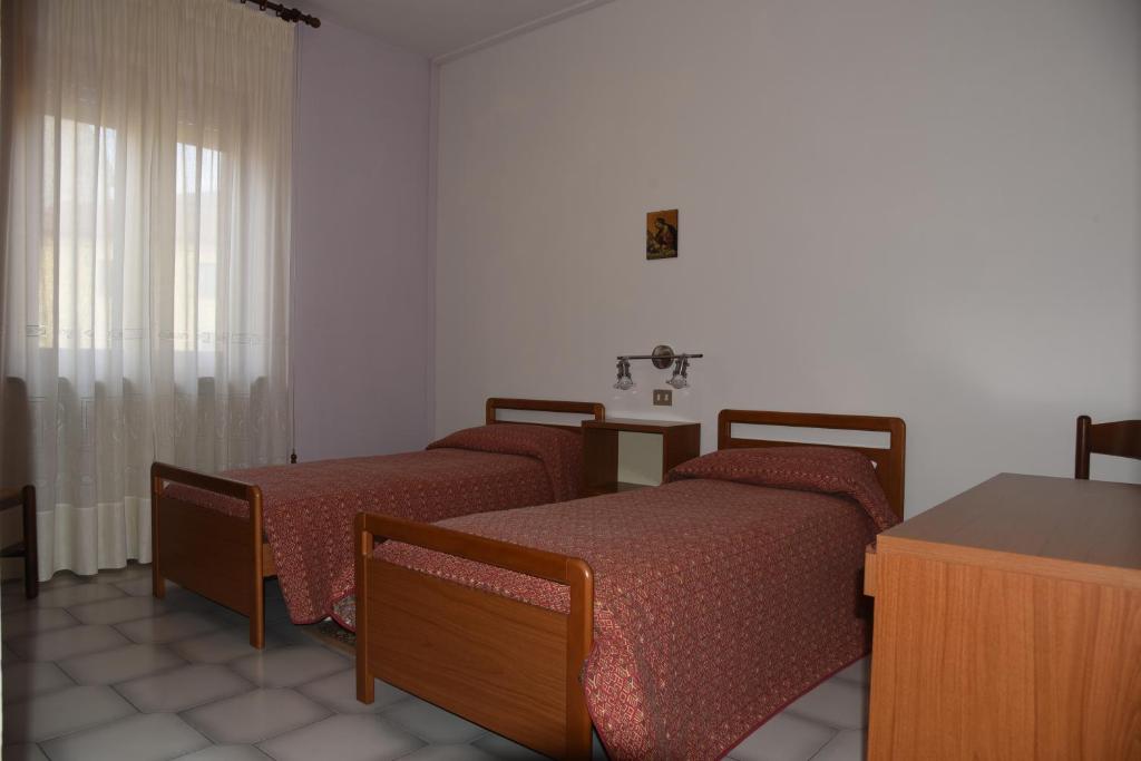 Postel nebo postele na pokoji v ubytování Albergo Dei Bersaglieri