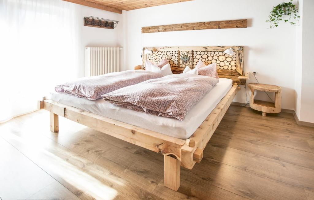 a bedroom with a wooden bed in a room at Haus Sonneneck in Fügen