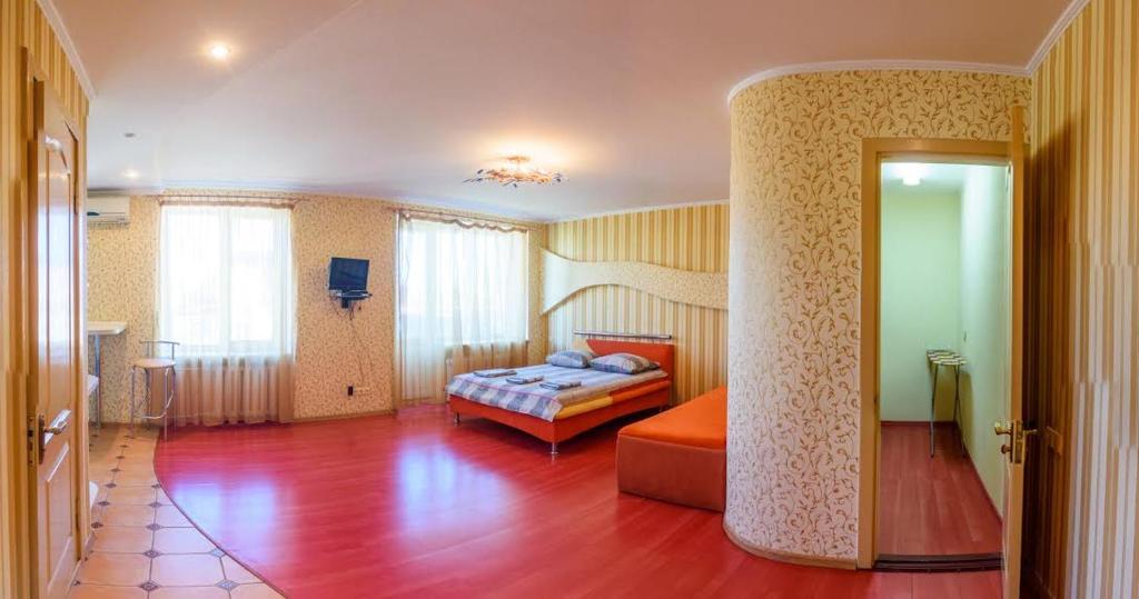 a bedroom with a bed in the middle of a room at Luxury studio in the Very center in Kherson