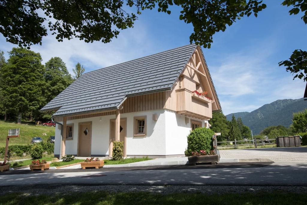 a small house with a gray roof at Apartments Alp in Bohinj
