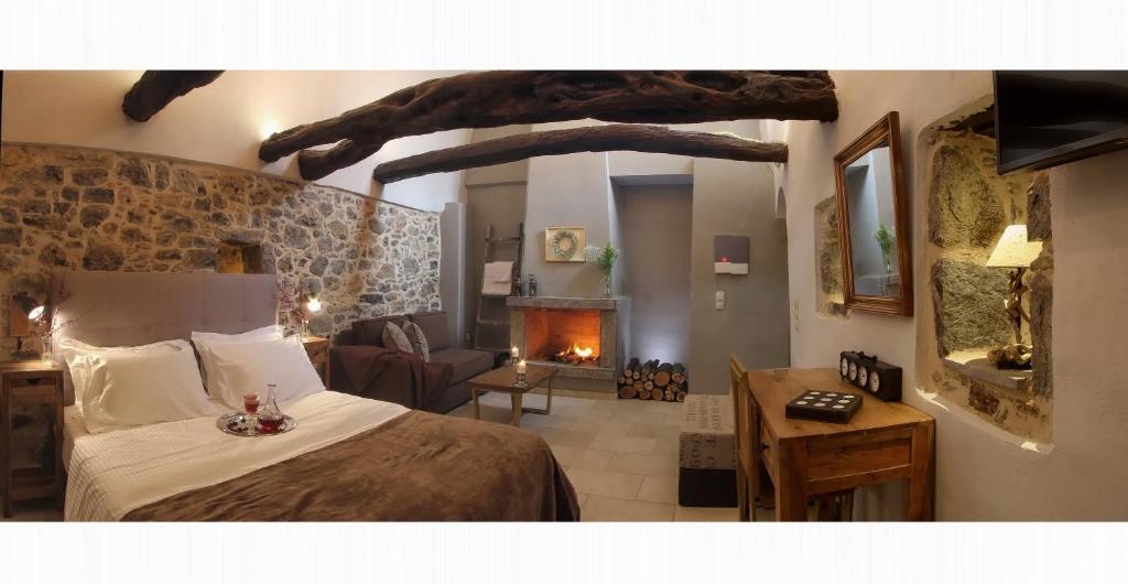 a bedroom with a bed and a living room with a fireplace at Mesta Mastic in Mestá