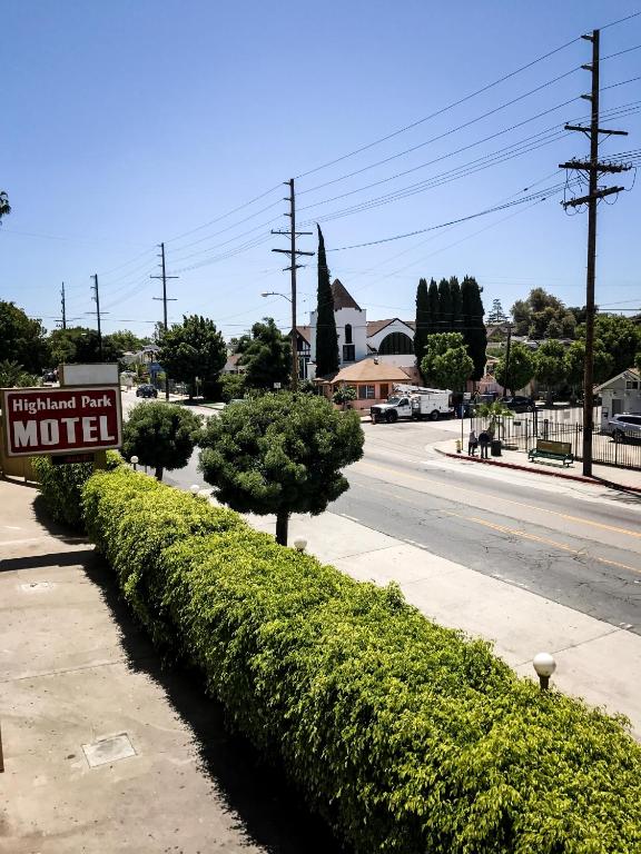 a sign for a motel on the side of a street at Highland Park Motel in Los Angeles