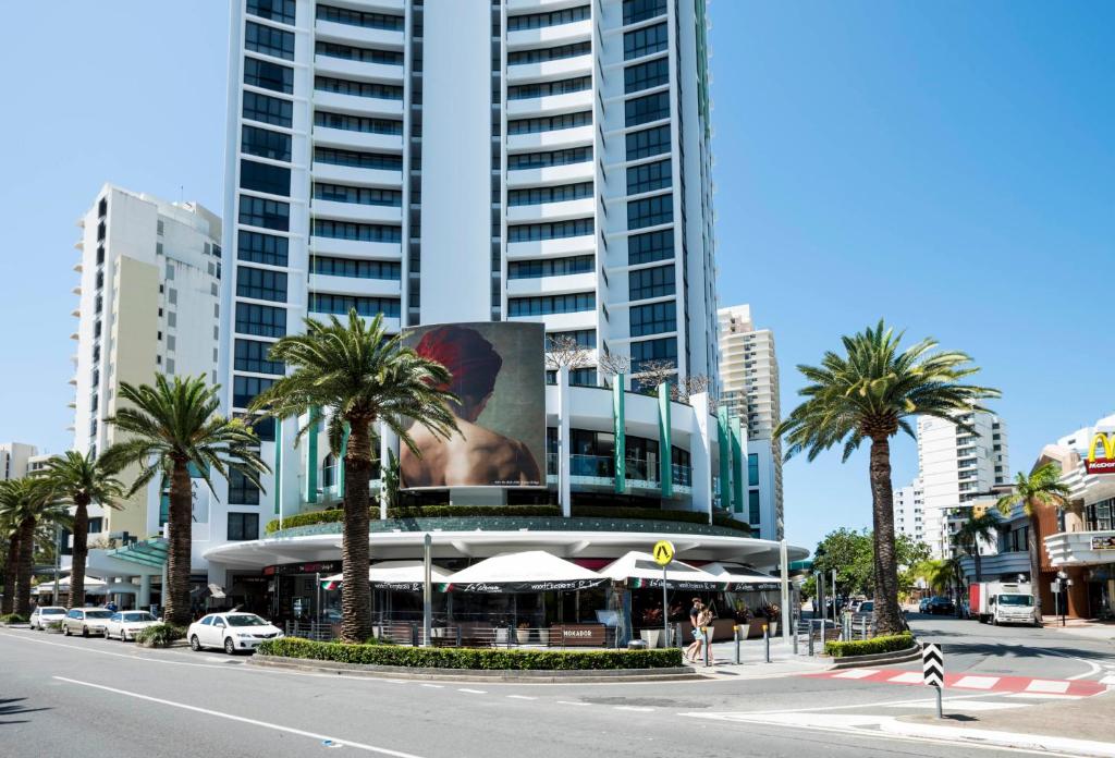 a building with a picture of a woman on it at Aria Apartments in Gold Coast