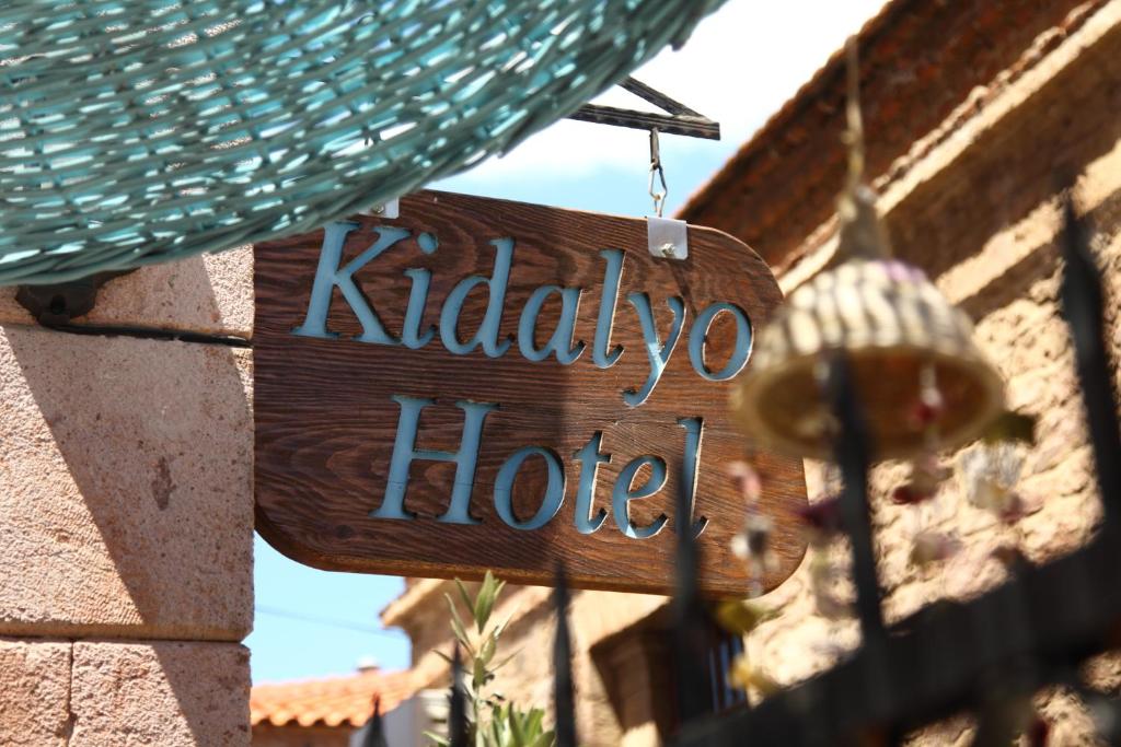 
a street sign on a brick building at Kidalyo Hotel - Special Category in Ayvalık
