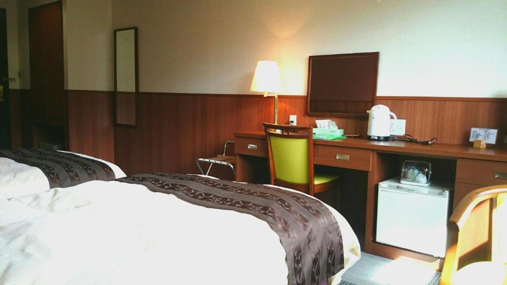 Postel nebo postele na pokoji v ubytování Nezame Hotel