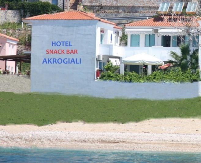 a hotel shark bar aquarium sign in front of a building at Akrogiali Hotel in Plomarion