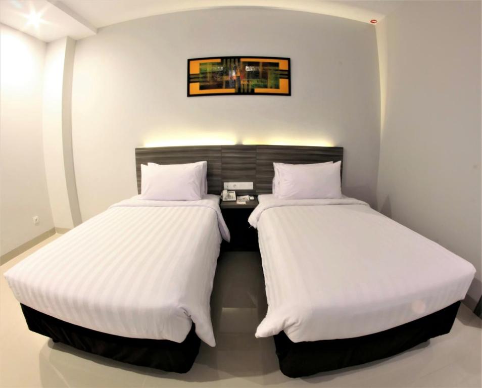 Tempat tidur dalam kamar di Urban Style by Front One