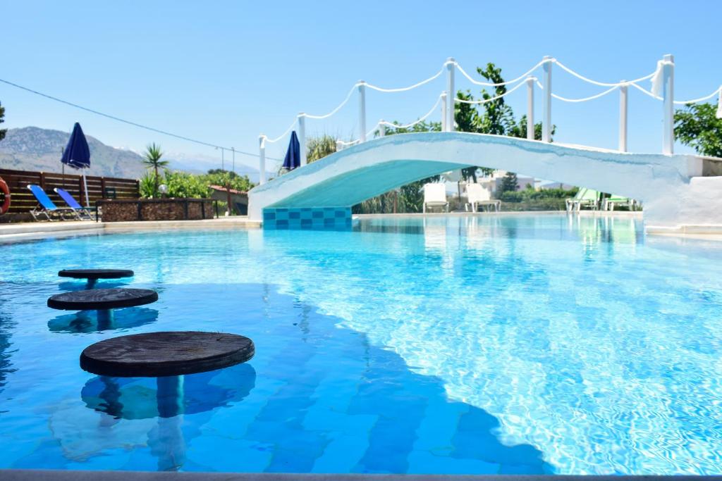 a pool at a resort with a water slide at Dias in Georgioupolis