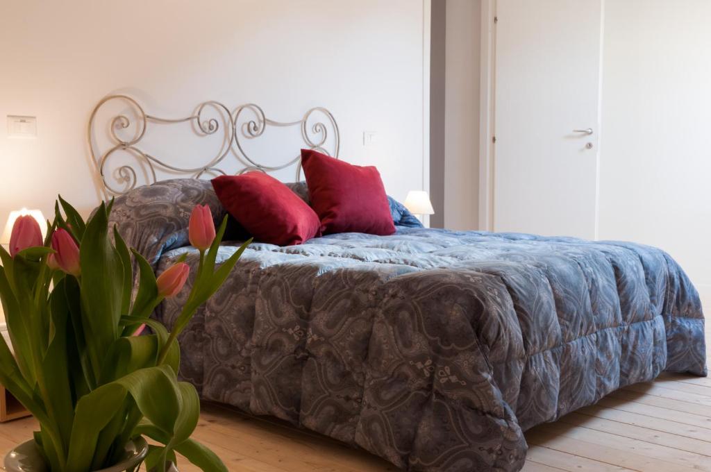 a bed with red pillows on it in a bedroom at Quiet Home Terracina Apartments in Terracina