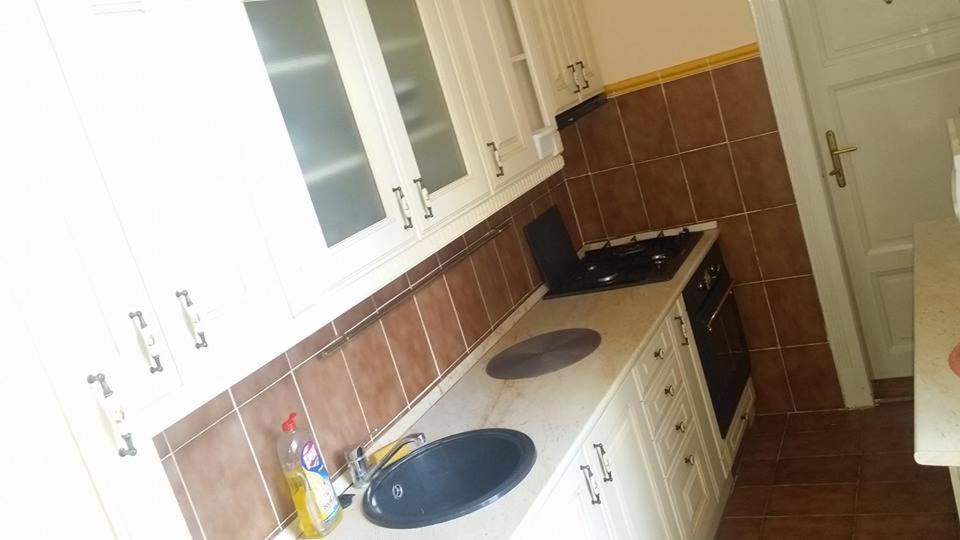 a kitchen with two sinks and a counter top at Horváth Apartmanház in Kaposvár