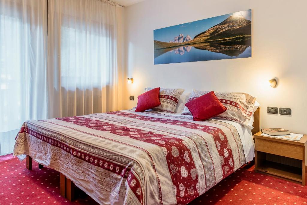 Postel nebo postele na pokoji v ubytování Hotel La Montanina