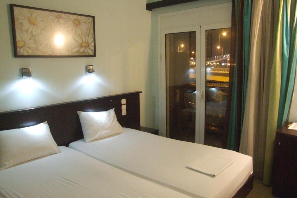 Postel nebo postele na pokoji v ubytování Hotel Georgios