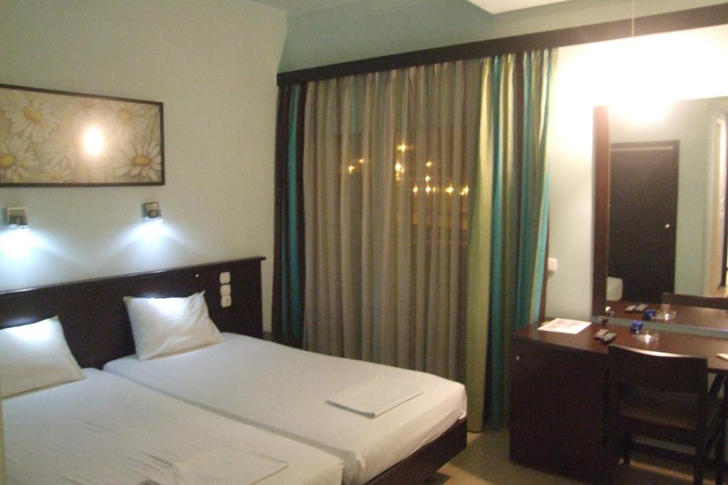 Postel nebo postele na pokoji v ubytování Hotel Georgios