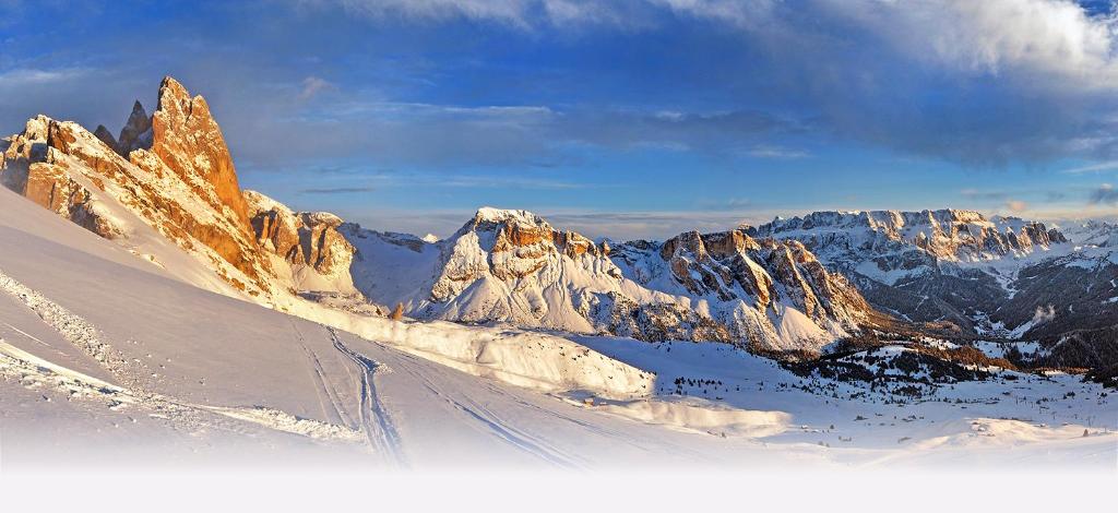 a snow covered mountain range with a ski slope at Residence Granvara in Ortisei