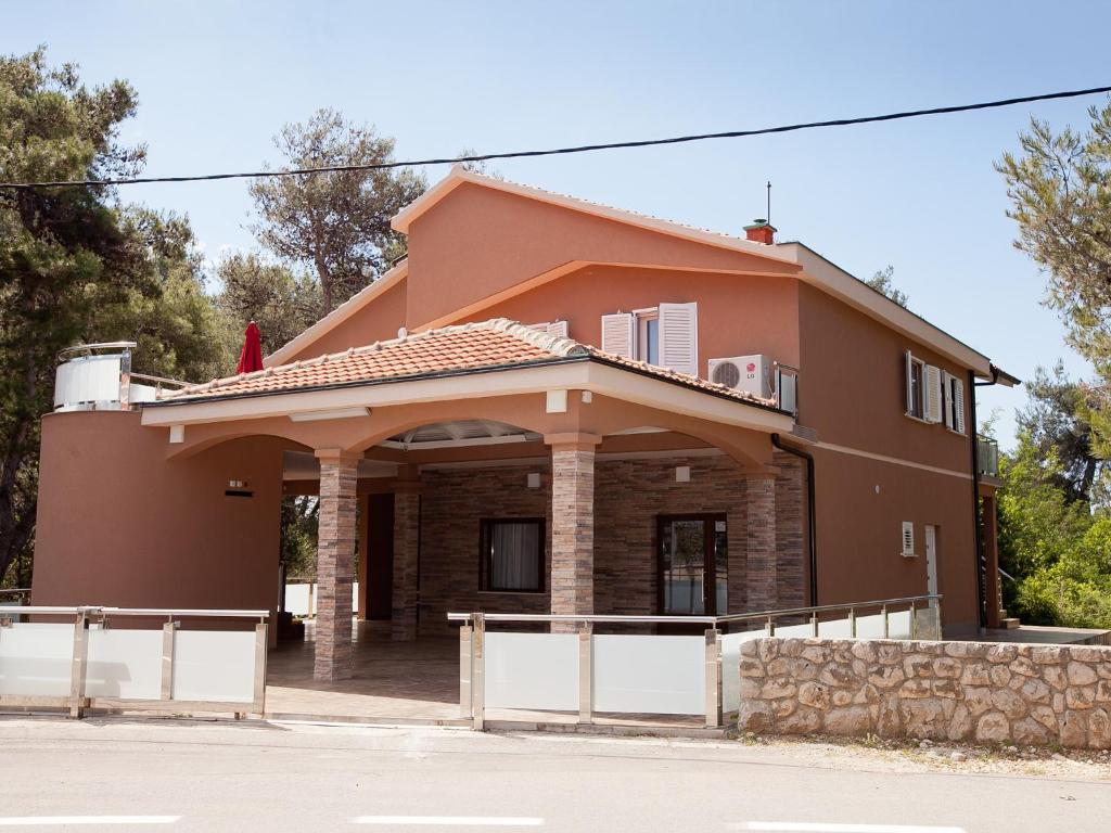 a house with a gate in front of it at Apartments Marija in Vir