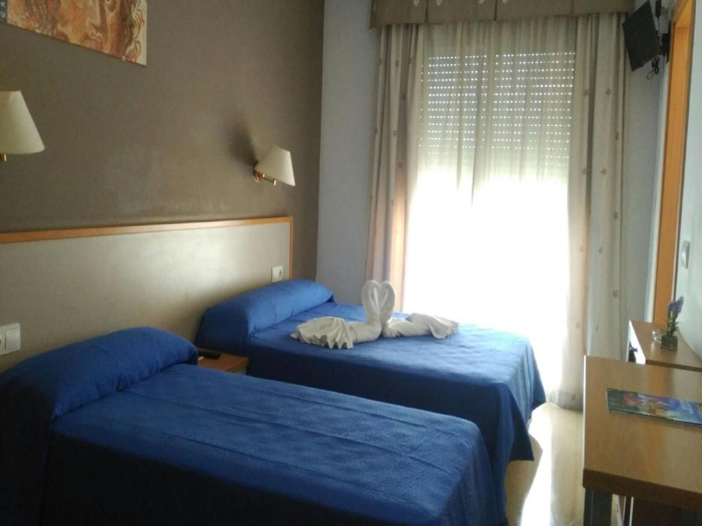 Postel nebo postele na pokoji v ubytování Hotel Cosmos Tarragona