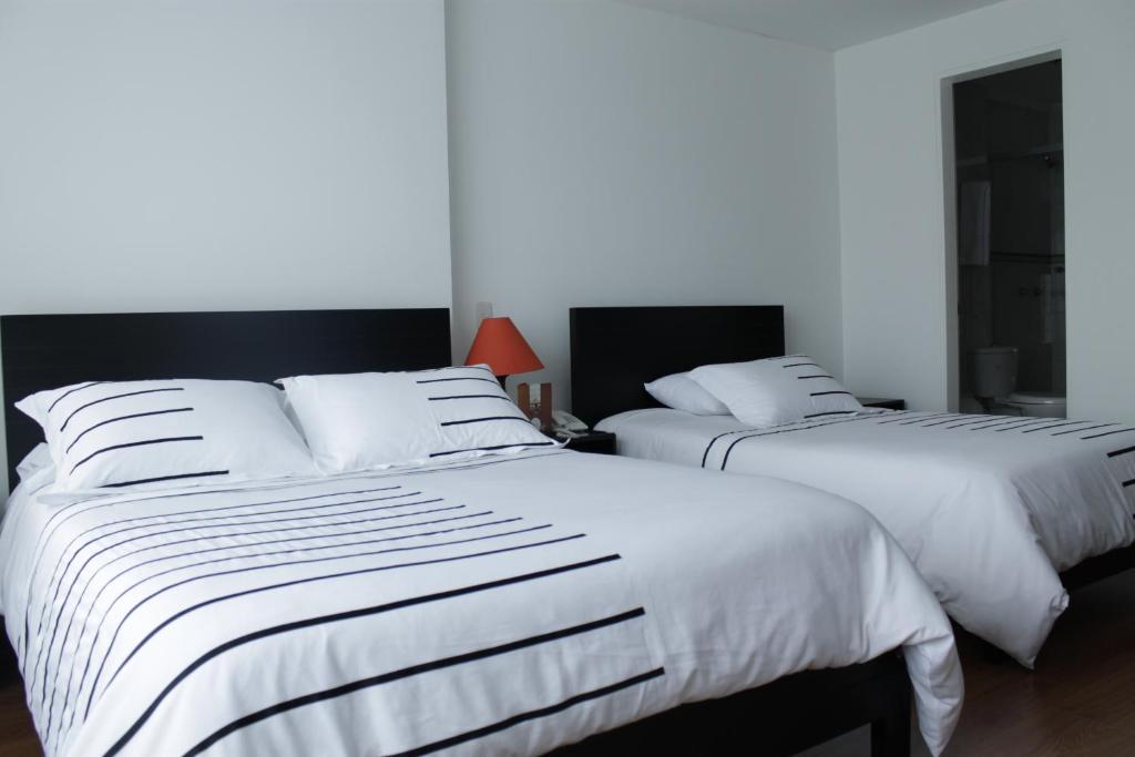 Postel nebo postele na pokoji v ubytování Hotel Real Estación