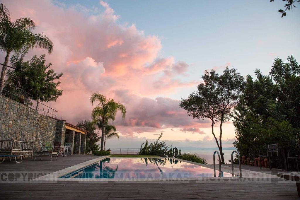 a swimming pool with a view of the ocean at Villa Mos in Kalamata