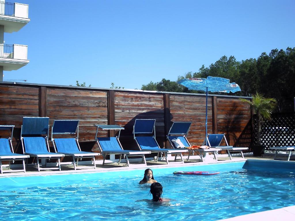 two people in the swimming pool at a hotel at Hotel Viking in Rimini