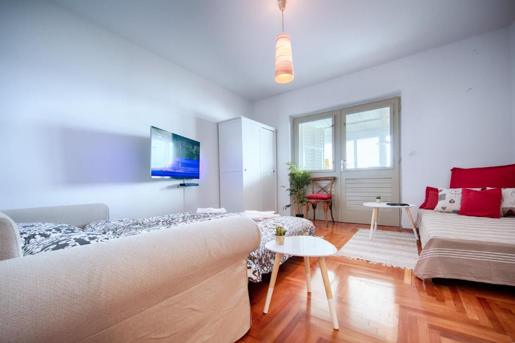 a living room with a couch and a table at Bellevue Apartment Hvar in Hvar