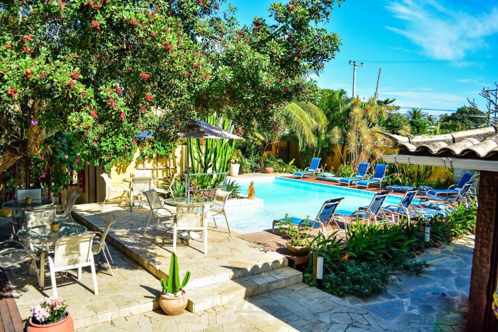 eine Terrasse mit Stühlen und einem Pool in der Unterkunft Pousada do Namorado in Búzios