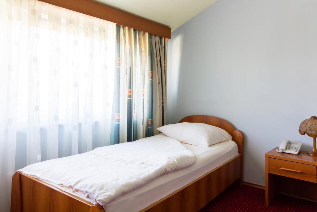 Postel nebo postele na pokoji v ubytování Hotel Sunce Sarajevo Vogosca