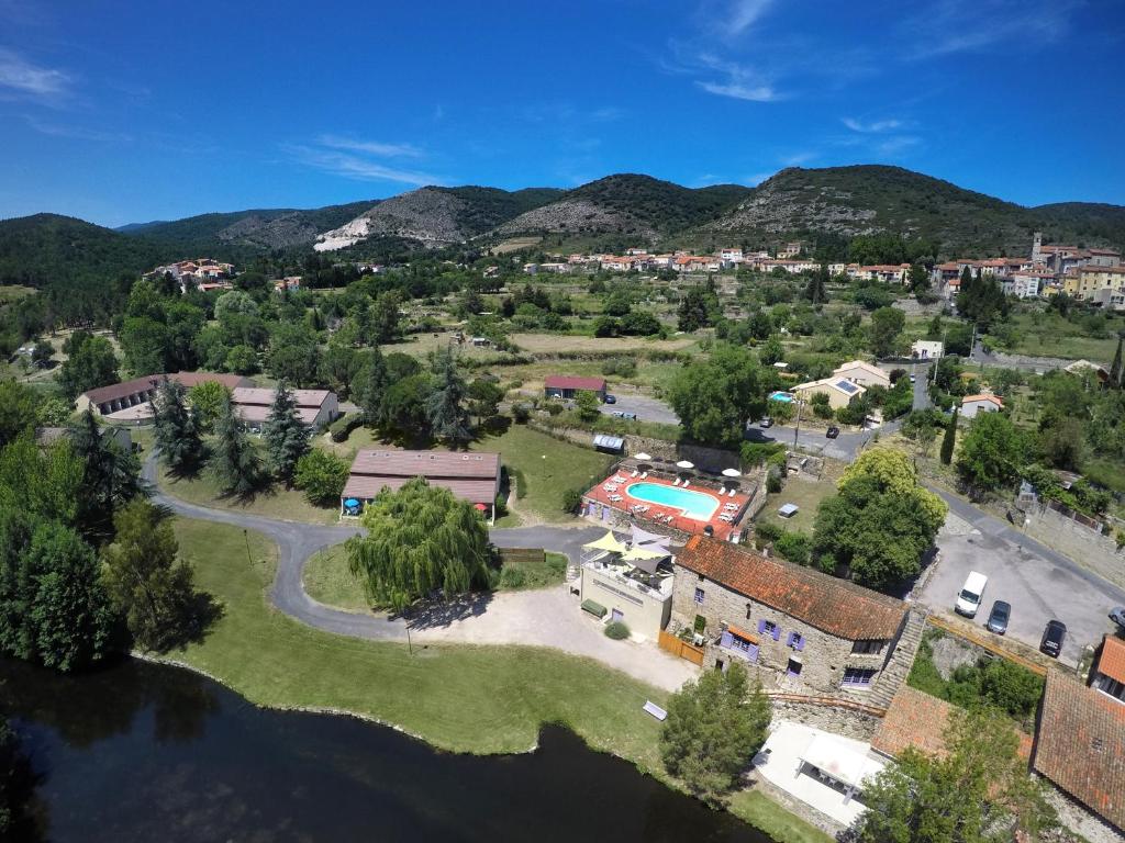 an aerial view of a town with mountains in the background at Le Moulin de Sournia in Sournia