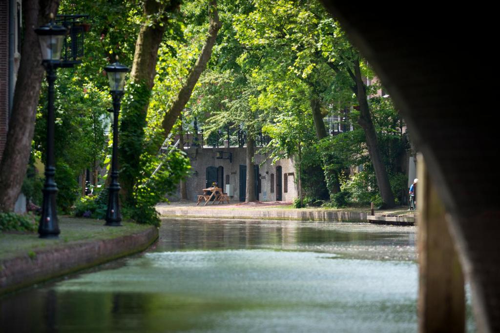 
a river with trees and houses in it at Hotel Oudegracht in Utrecht
