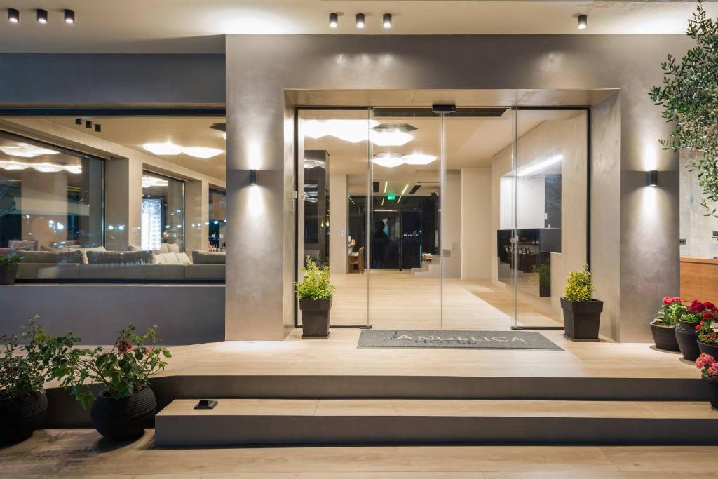 a lobby of a building with potted plants at Angelica Hotel in Limenas