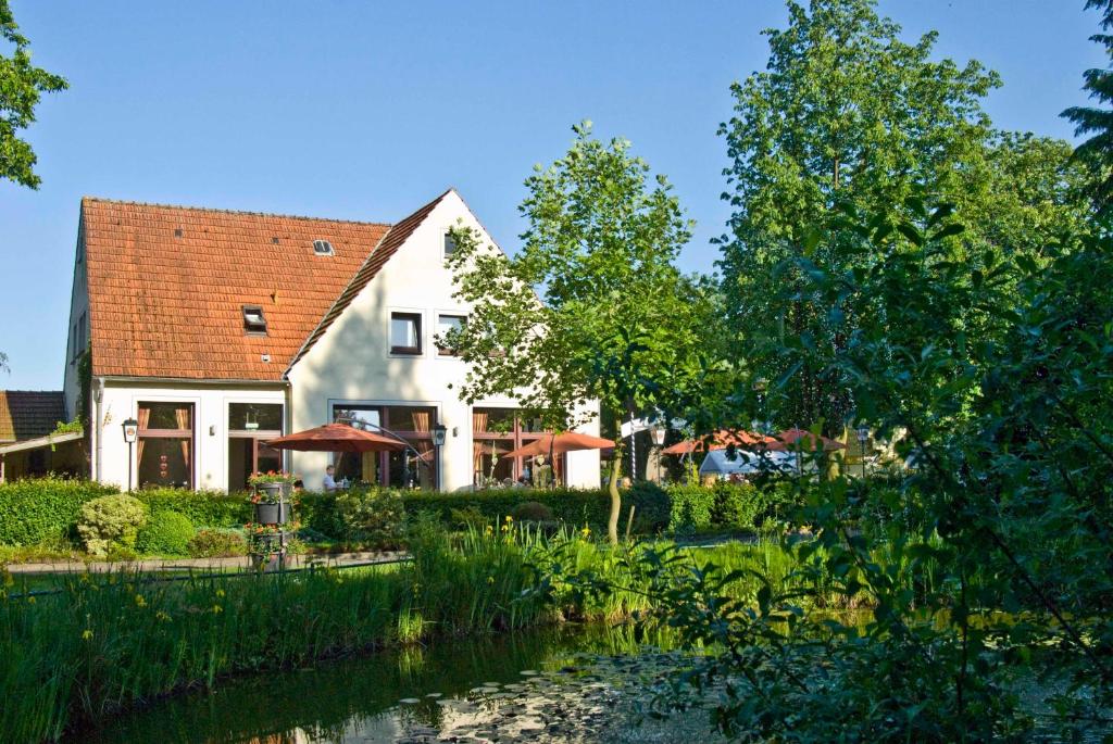 una casa con un río delante de ella en Nierswalder Landhaus, en Goch