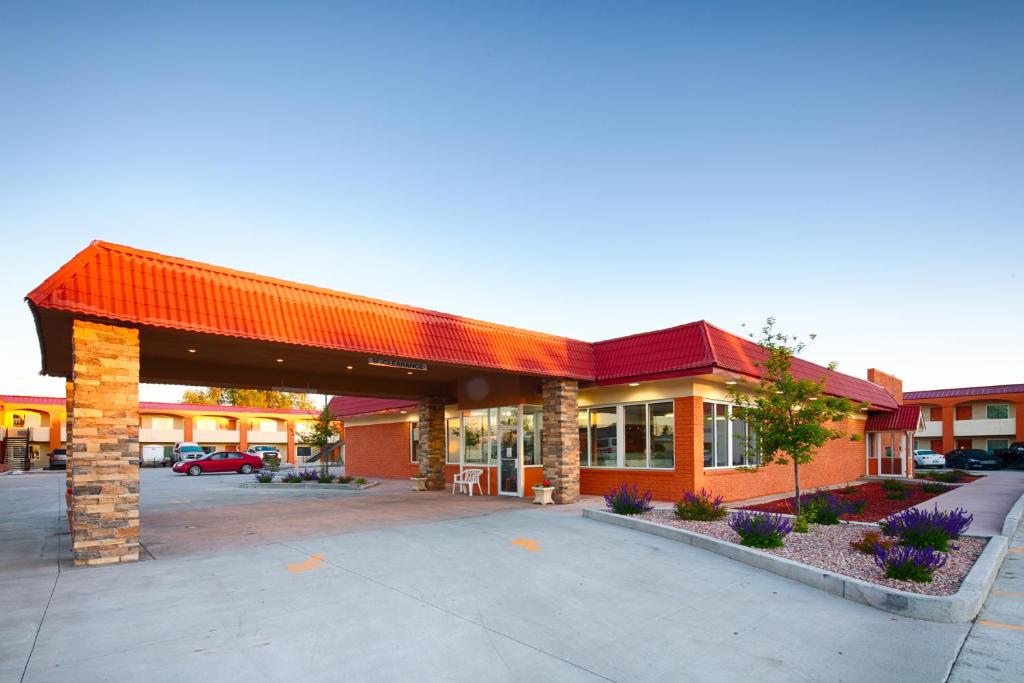 an empty parking lot in front of a building at LaJunta Inn in La Junta