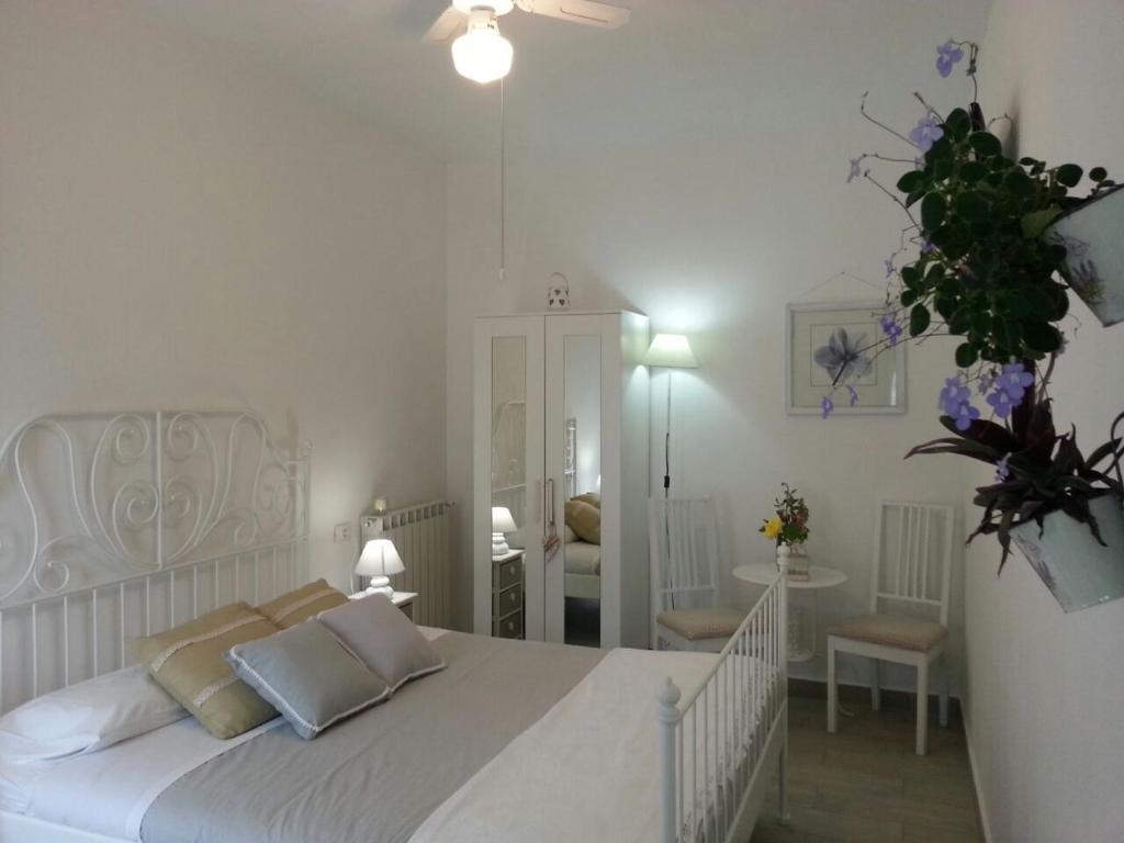 a white bedroom with a white bed and a room at Message in a Bottle Bed and Breakfast in Camporosso