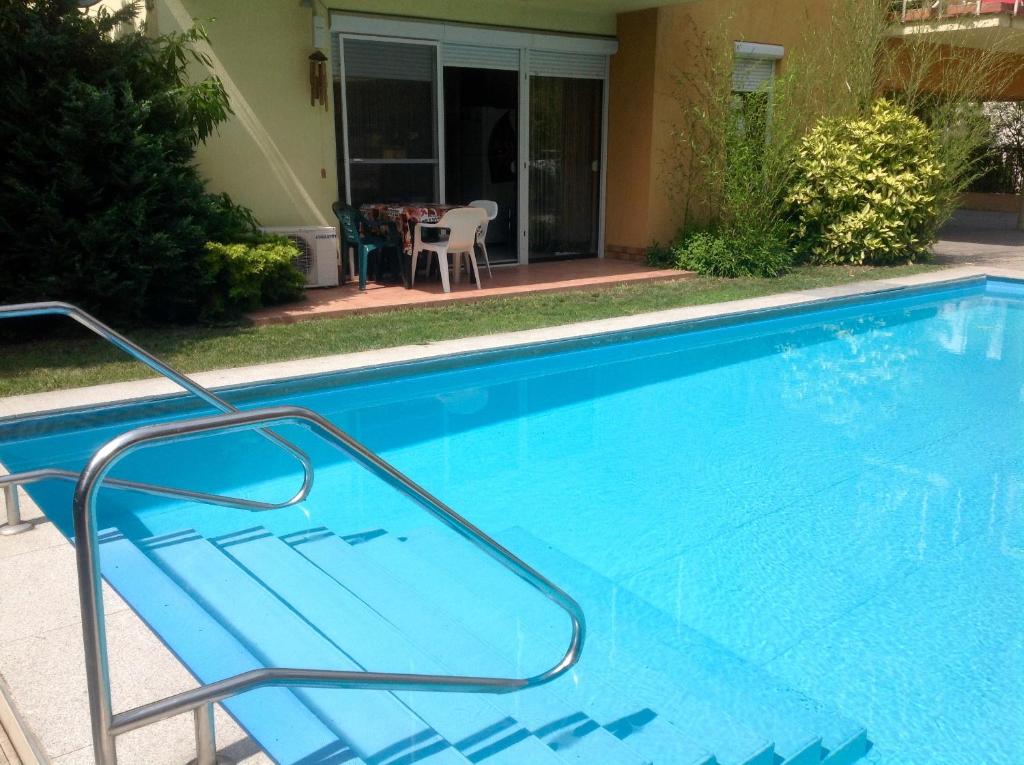 a large blue swimming pool in front of a house at Siófok paradise in Siófok