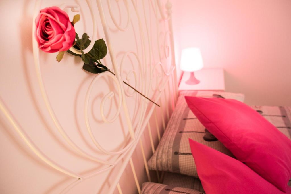 a bedroom with a red rose on the wall at Appartamento in centro in Genoa