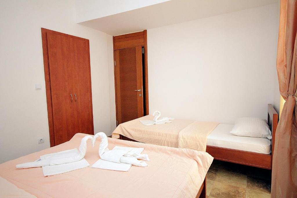 a hotel room with two beds with towels on them at Apartmani More in Sveti Stefan