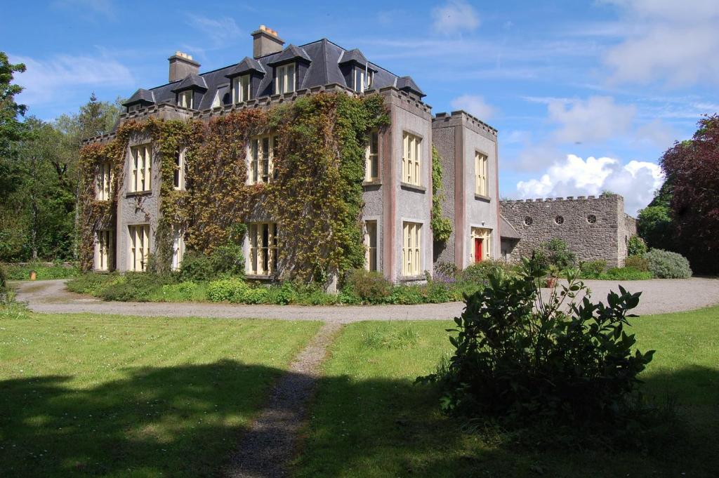 an old house with ivy on the side of it at Ardtarmon House in Sligo