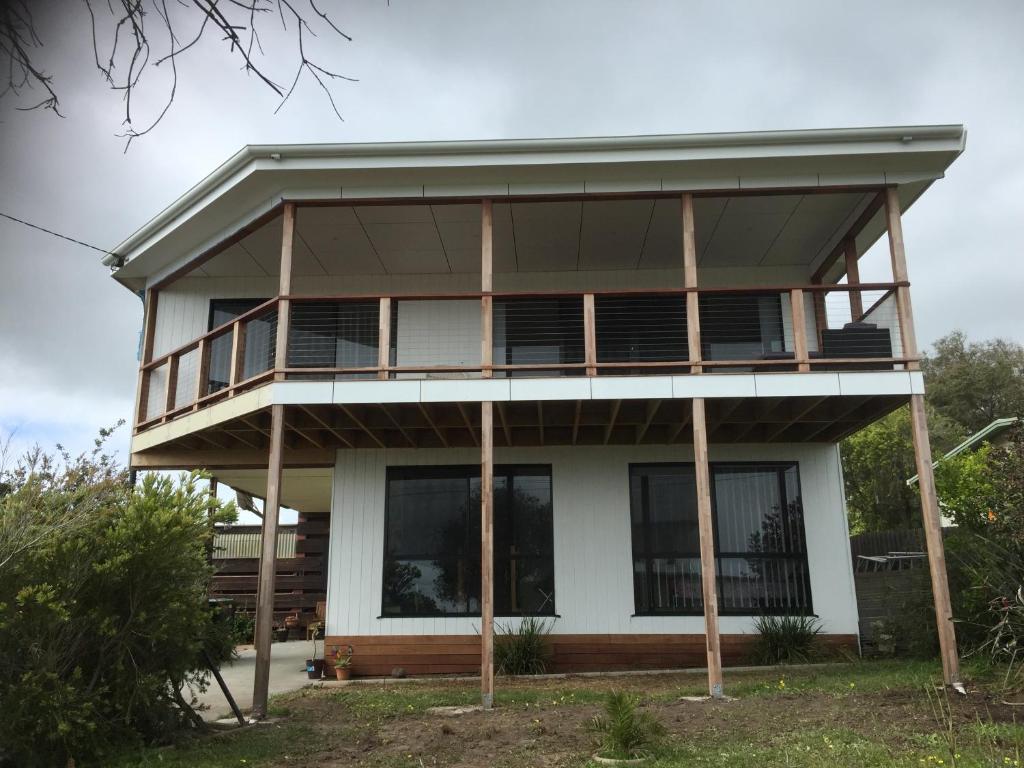 a house with a balcony on top of it at Bayviews in Portarlington