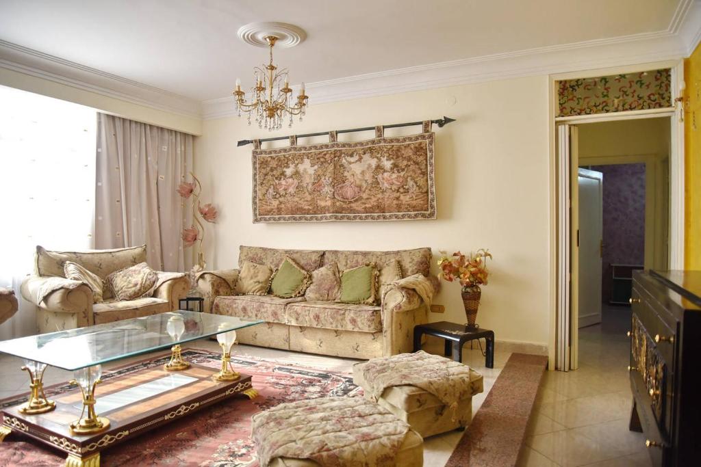 a living room with a couch and a glass table at Fancy apartment in front of City Stars in Cairo