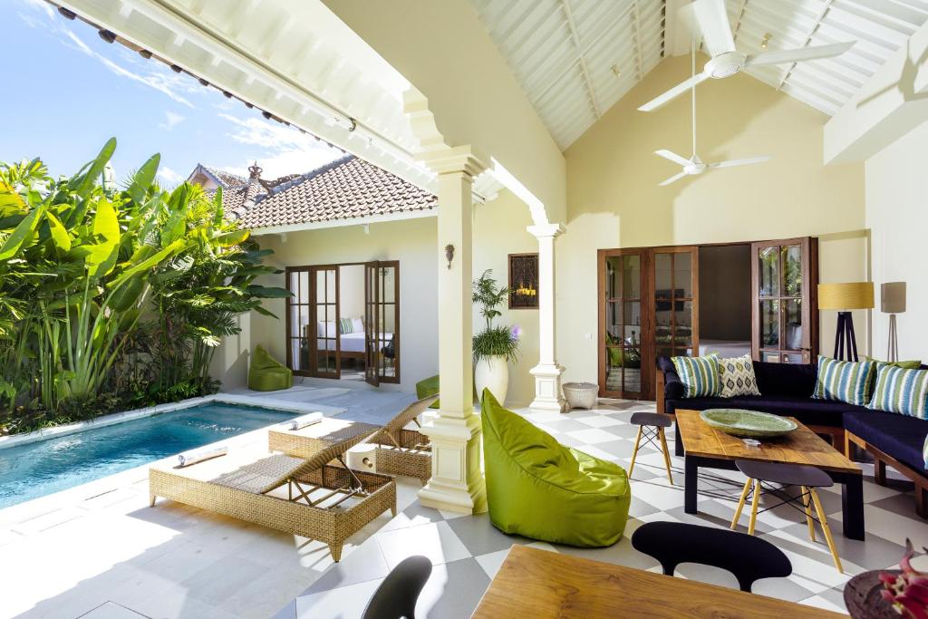 a living room with a pool and a villa at Villa Mandala in Seminyak